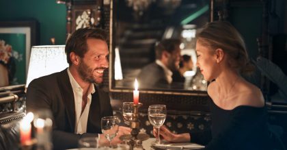 Man and woman enjoying romantic once-in-a-lifetime meal