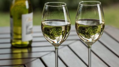 white wine ane wine glasses in a wooden table