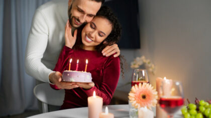 Husband is surprising his wife with birthday cake
