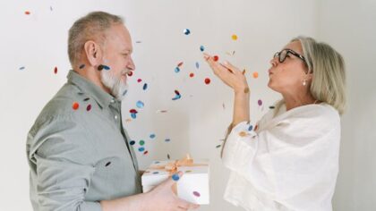 Grandma blowing confetti in her husband's face