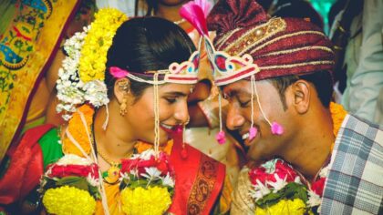 Man and Woman Wearing Traditional Wedding Attire Facing Each Other